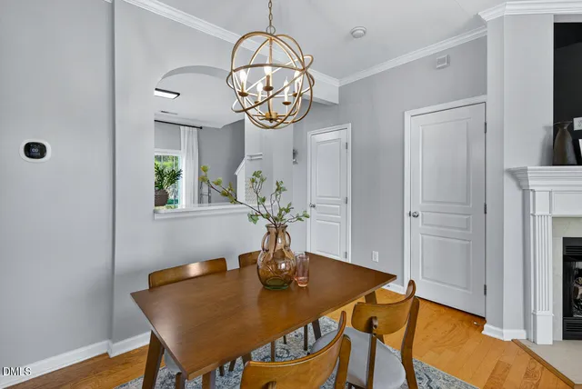 a view of a dining room with furniture wooden floor and a chandelier