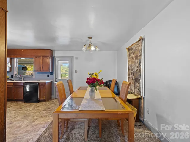 a view of a dining room with furniture and chandelier