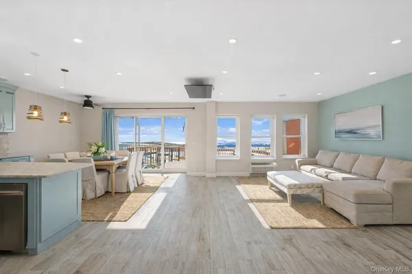 a large living room with stainless steel appliances granite countertop a couch and a view of living room