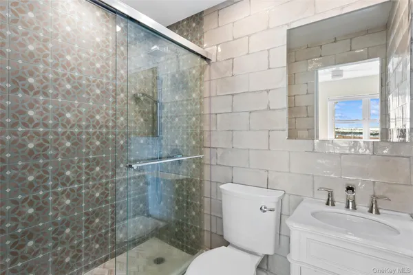 a bathroom with a toilet sink and shower