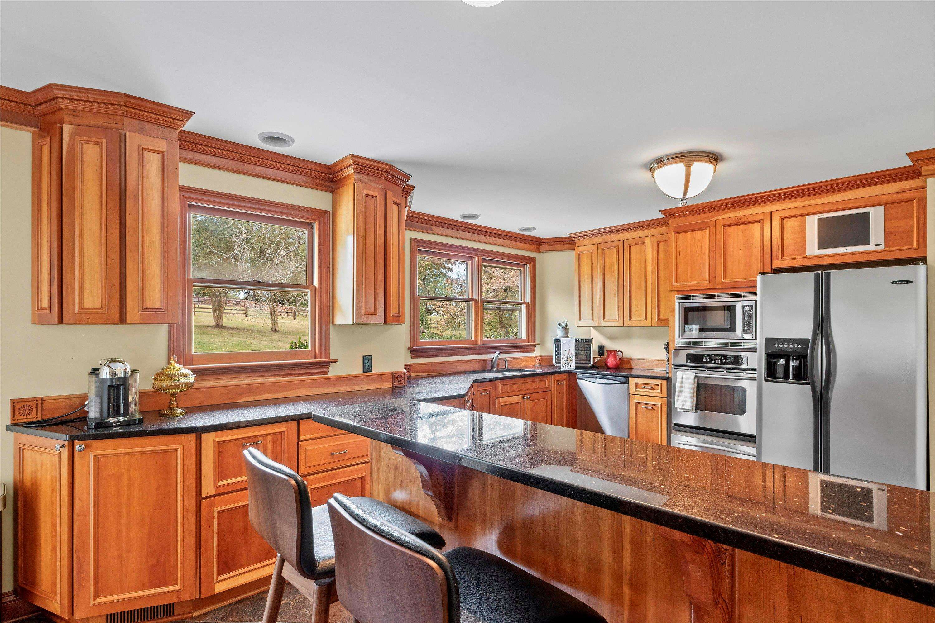 3509 Old Milburnie Road Raleigh, NC 27616 - Photo 18 of 74 a kitchen with stainless steel appliances a sink cabinets and a large window