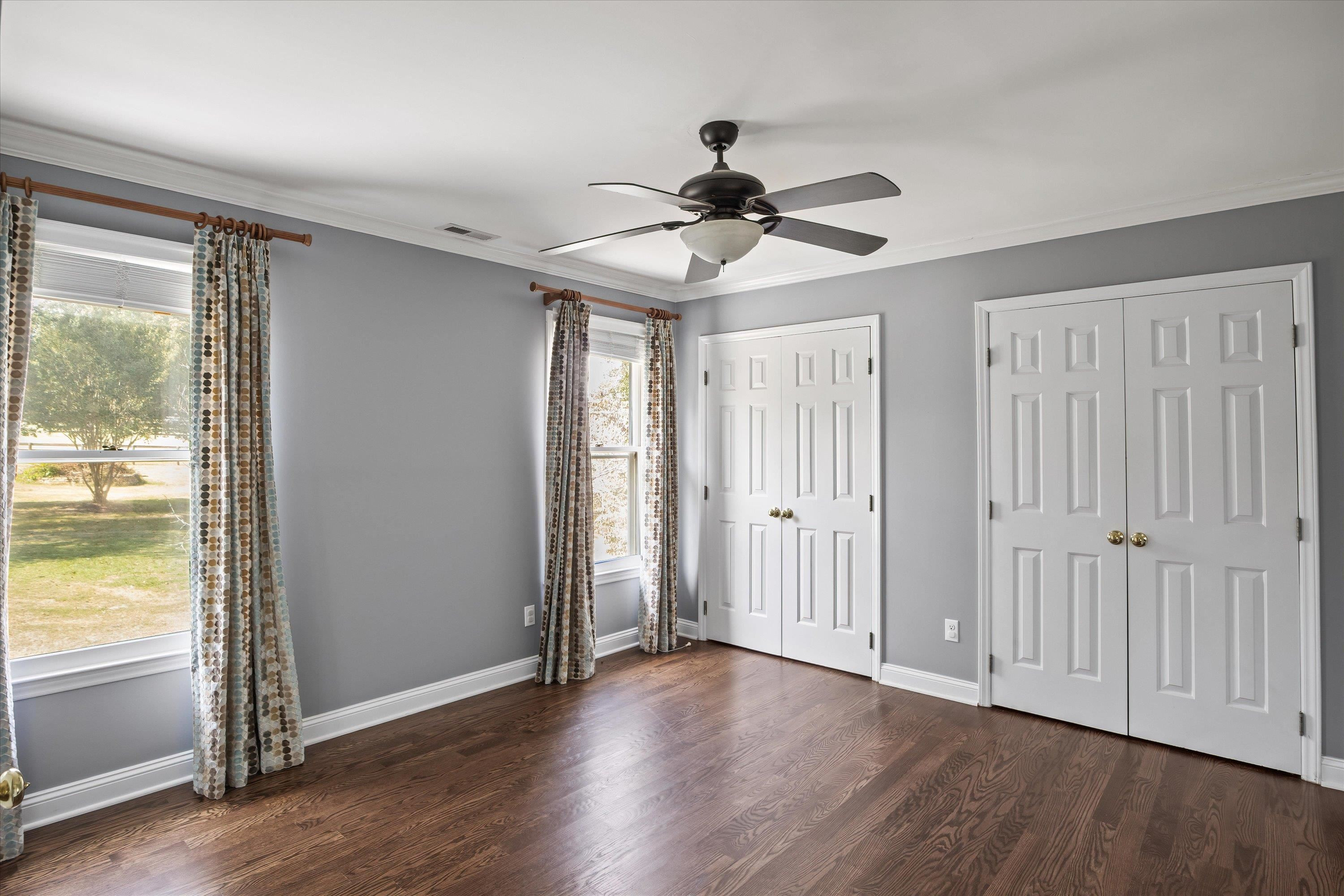 3509 Old Milburnie Road Raleigh, NC 27616 - Photo 41 of 74 an empty room with wooden floor fan and windows