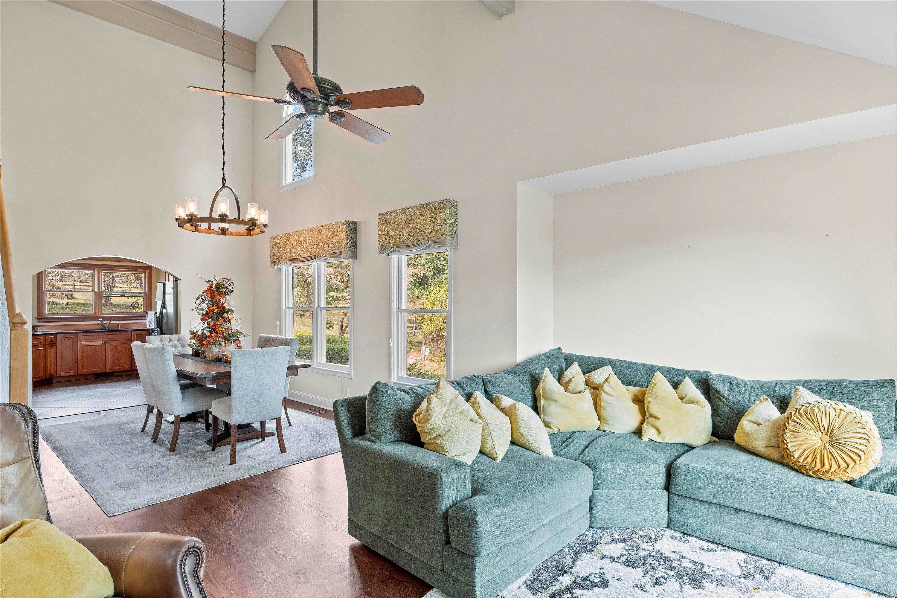 3509 Old Milburnie Road Raleigh, NC 27616 - Photo 10 of 74 a living room with furniture a rug and a chandelier