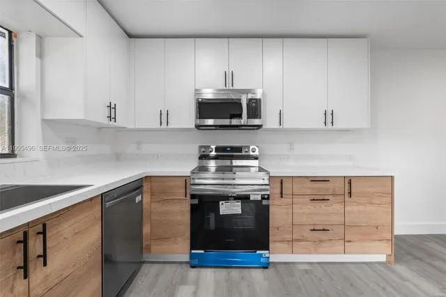 a kitchen with granite countertop a stove and a sink