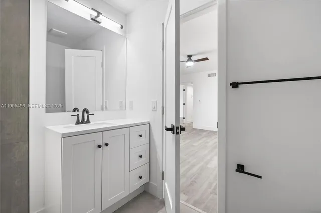 a bathroom with a double vanity sink a mirror and a shower