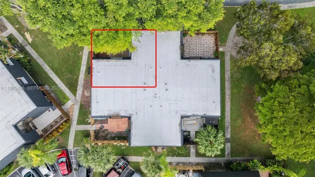 an aerial view of a house with a yard and potted plants