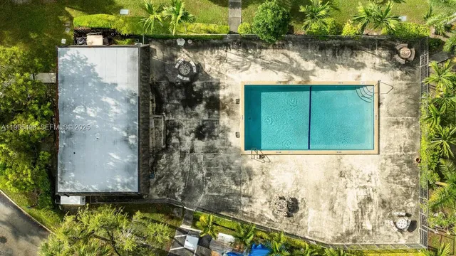 an aerial view of a house with a yard and trees