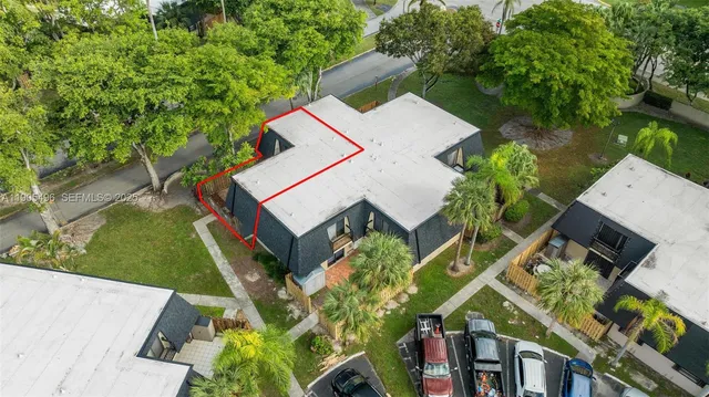 an aerial view of a house with a yard