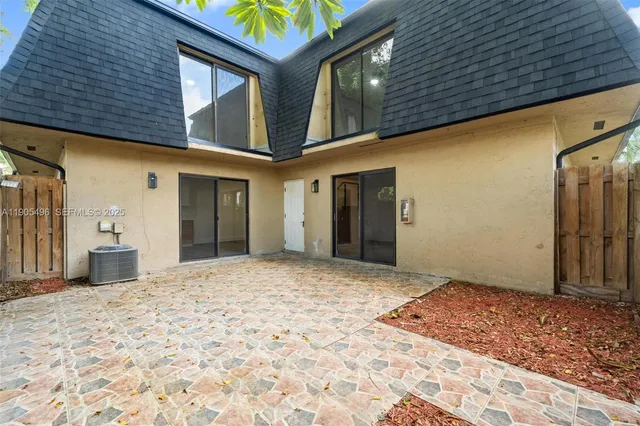 a view of a house with a wooden bench