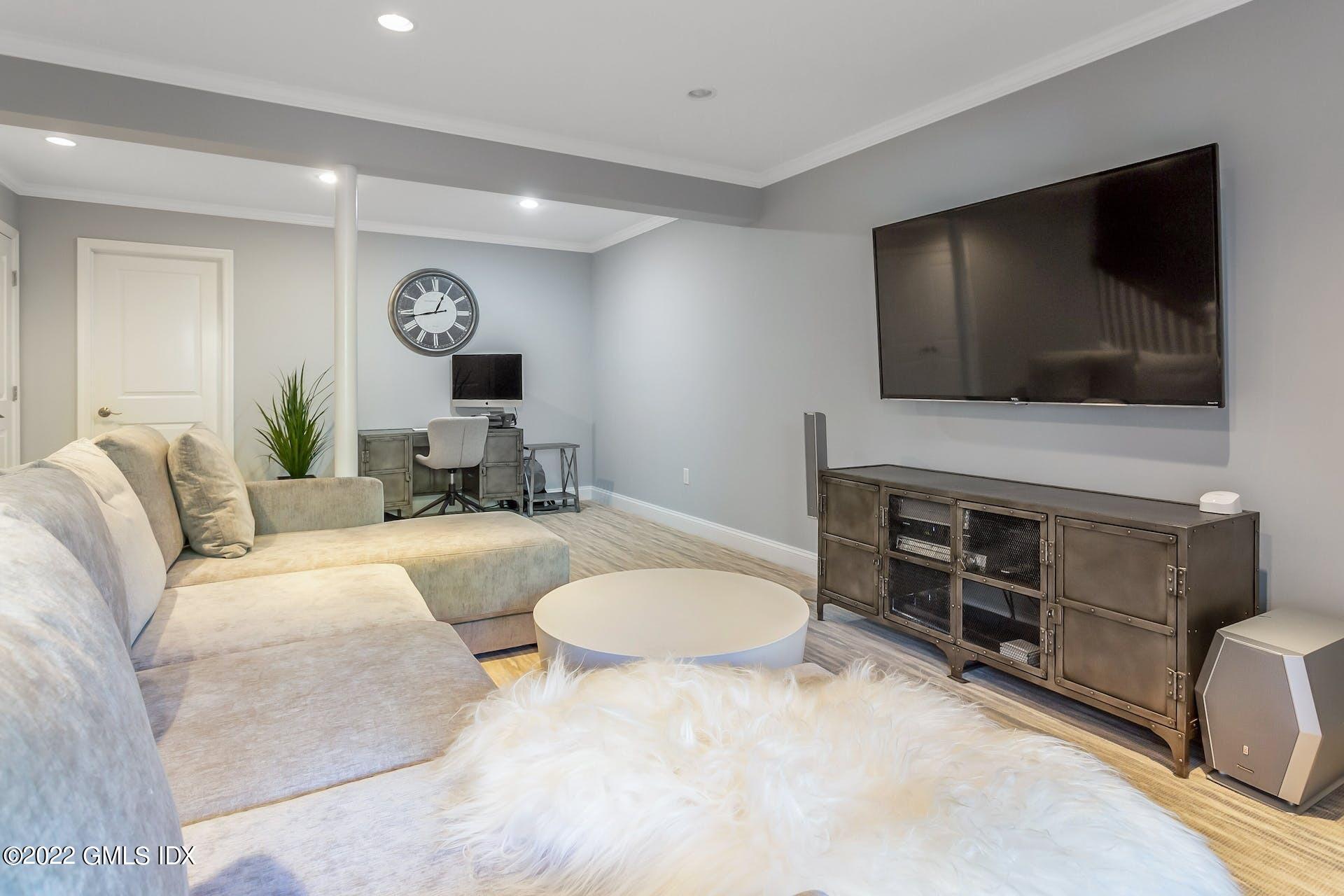 100 Silo Circle, Unit 100 Riverside, CT 06878 - Photo 11 of 22 a living room with furniture and a flat screen tv