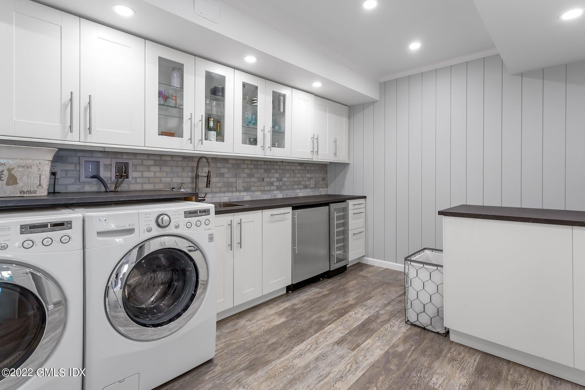 100 Silo Circle, Unit 100 Riverside, CT 06878 - Photo 12 of 22 a utility room with sink dryer and washer