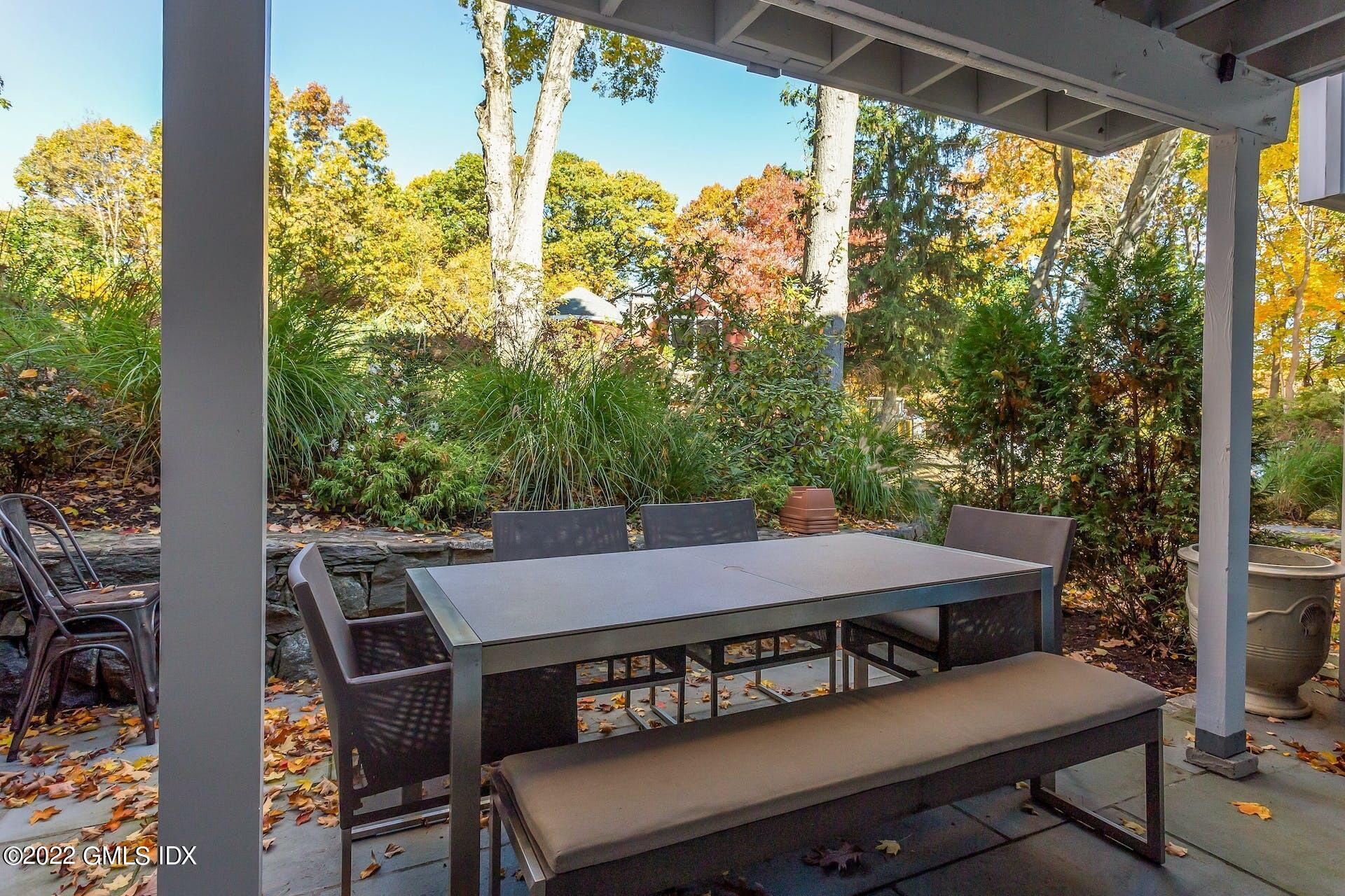100 Silo Circle, Unit 100 Riverside, CT 06878 - Photo 13 of 22 a view of a patio with table and chairs and potted plants