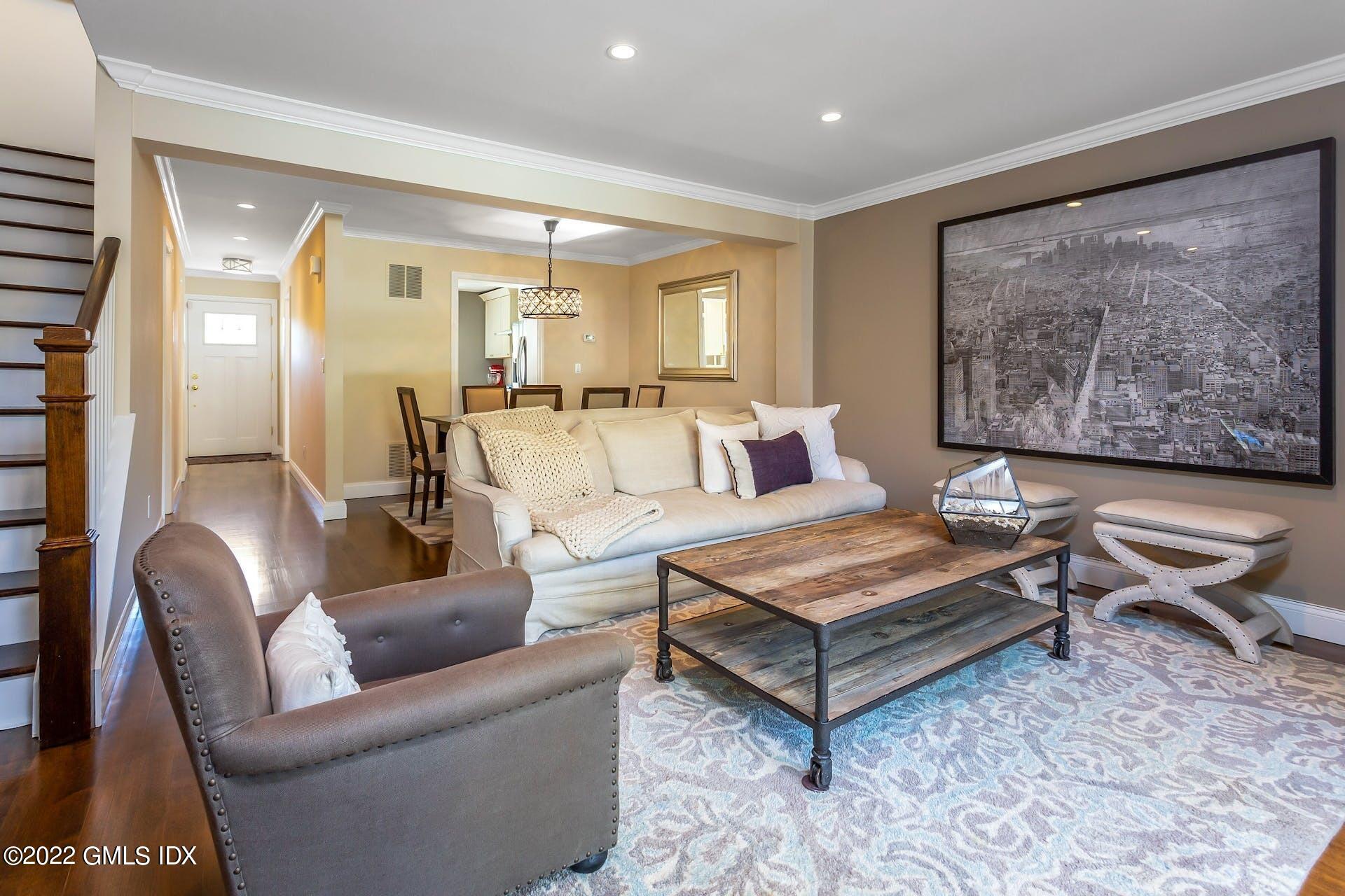 100 Silo Circle, Unit 100 Riverside, CT 06878 - Photo 2 of 22 a living room with furniture a rug and a painting