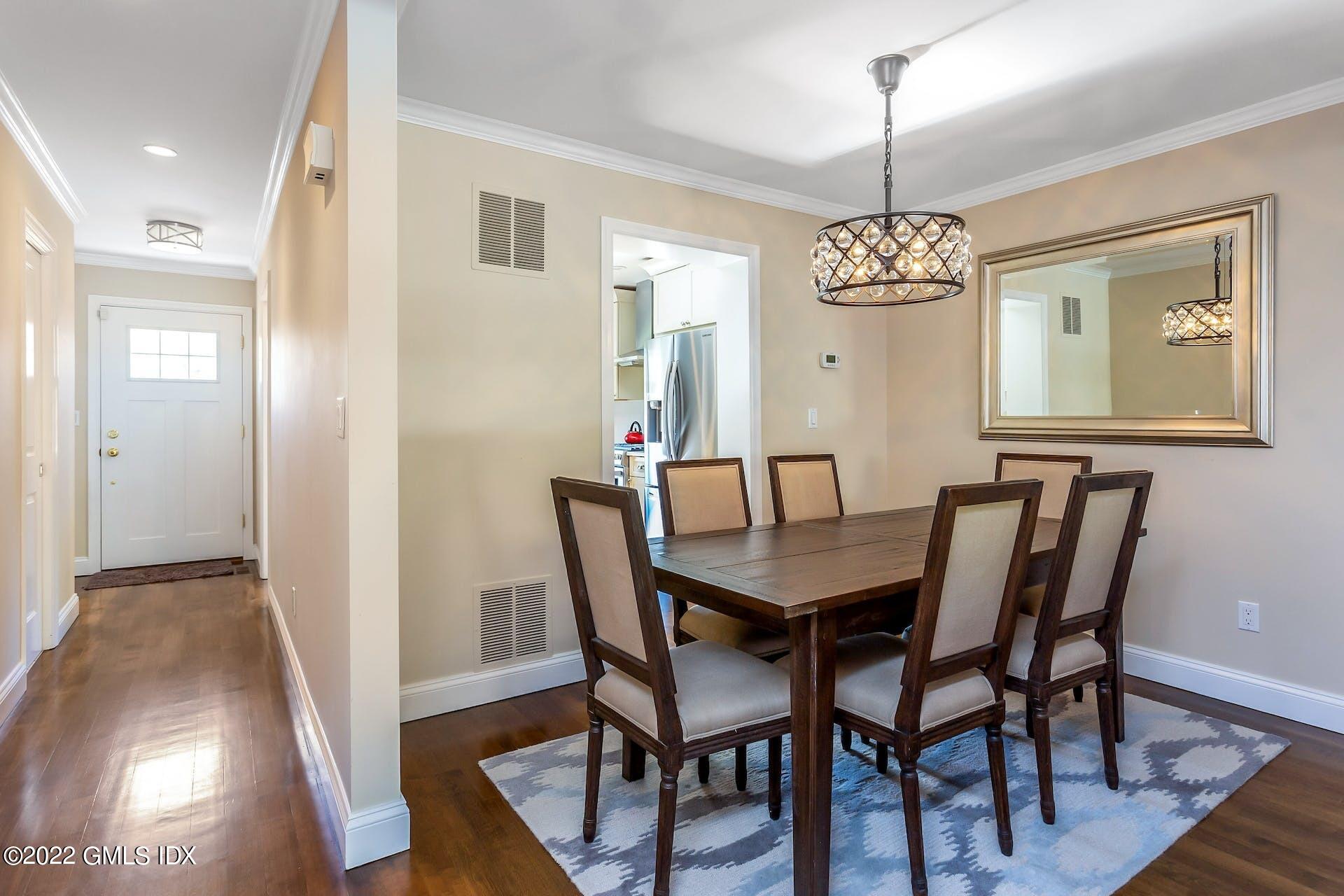 100 Silo Circle, Unit 100 Riverside, CT 06878 - Photo 3 of 22 a view of a dining room with furniture wooden floor and chandelier
