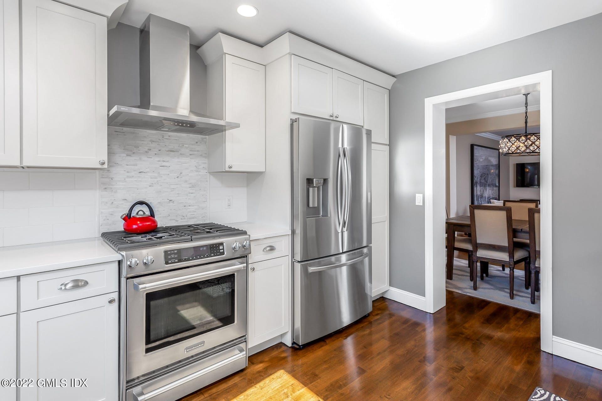100 Silo Circle, Unit 100 Riverside, CT 06878 - Photo 4 of 22 a kitchen with a refrigerator and a stove top oven