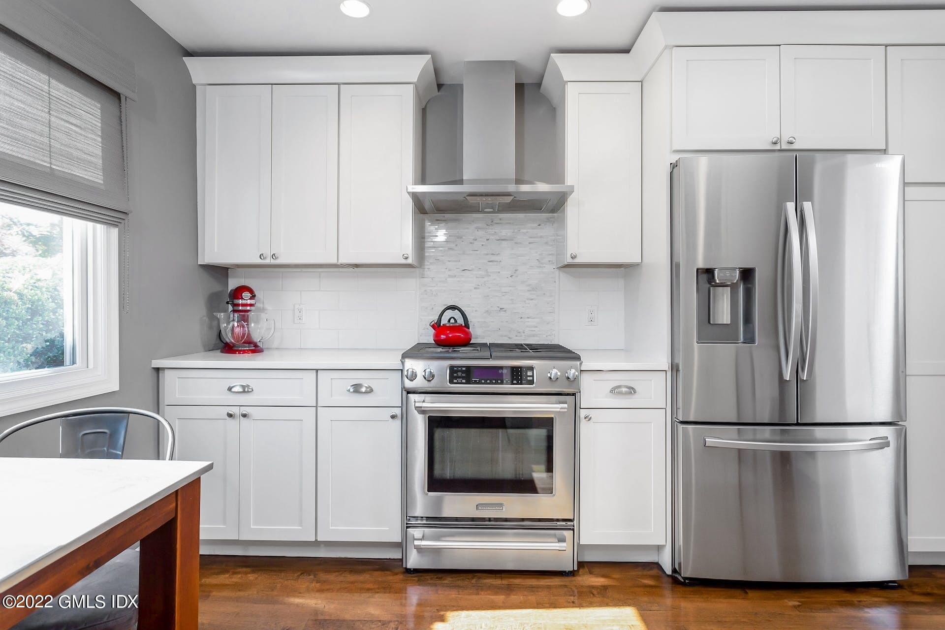 100 Silo Circle, Unit 100 Riverside, CT 06878 - Photo 5 of 22 a kitchen with a refrigerator sink and cabinets