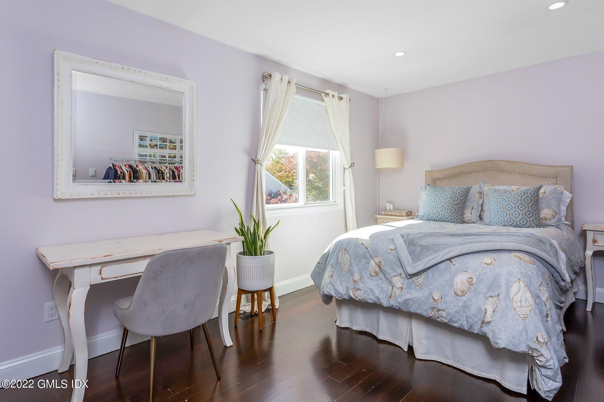 100 Silo Circle, Unit 100 Riverside, CT 06878 - Photo 9 of 22 a bedroom with a bed and a table in it