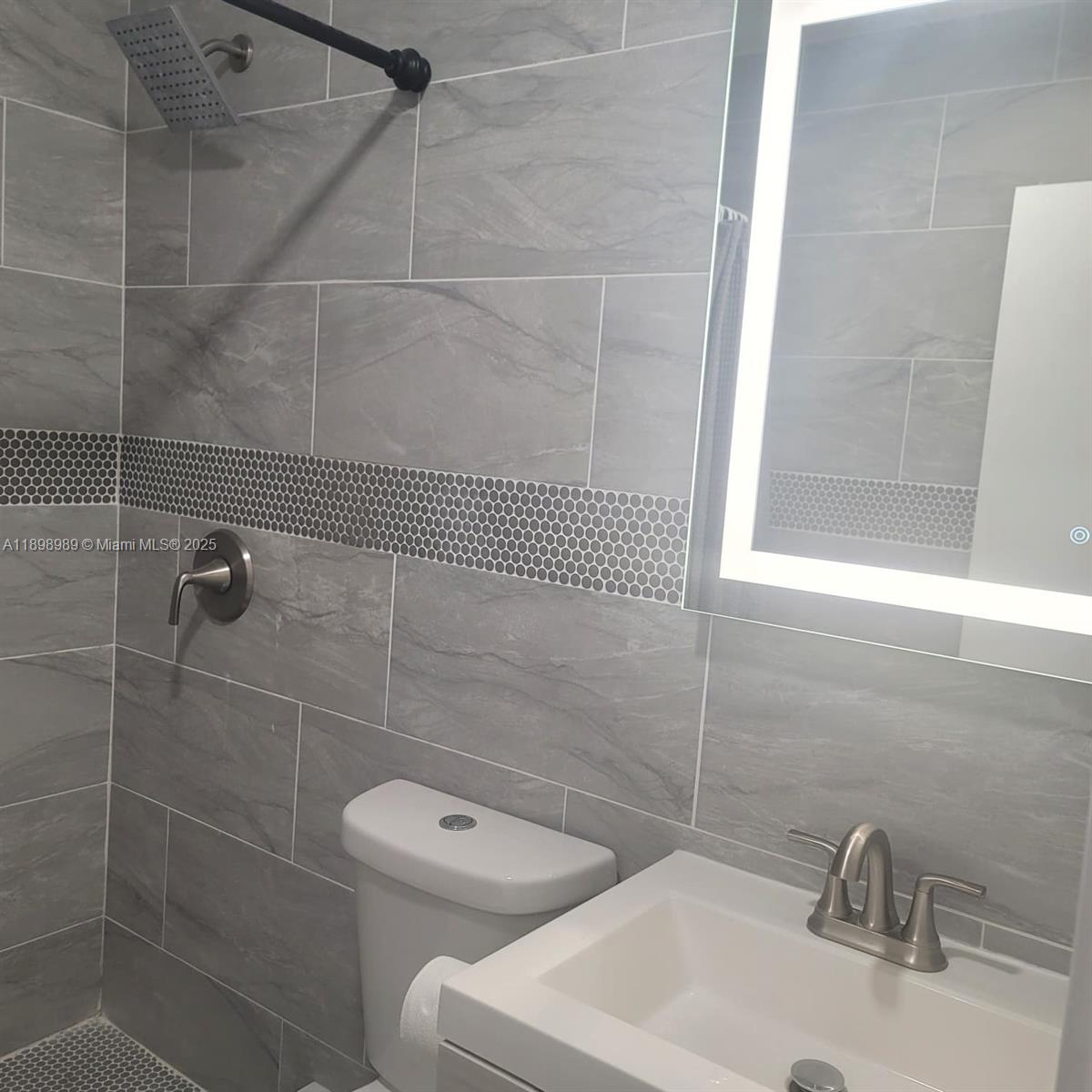 1120 Southwest 96th Avenue, Unit 1 Miami, FL 33174 - Photo 6 of 9 a bathroom with a sink a toilet and shower