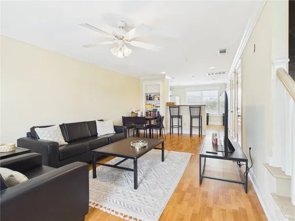 a living room with furniture and kitchen view