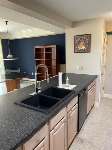 a kitchen with stainless steel appliances granite countertop a sink and a granite counter tops