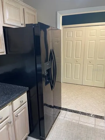a kitchen with a refrigerator and cabinets