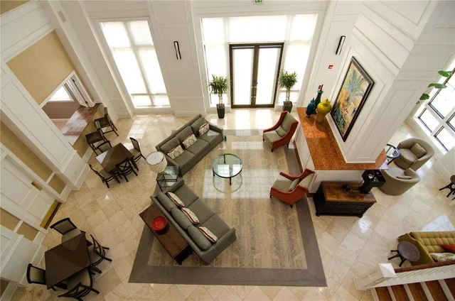 a living room with fireplace furniture and a large window