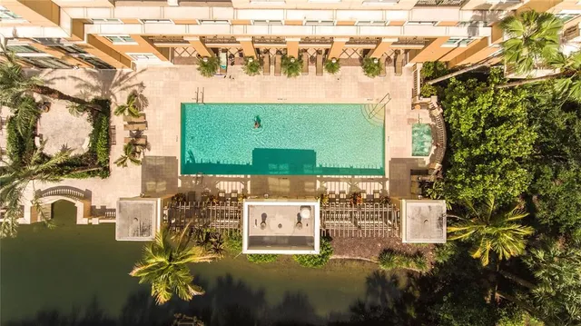a front view of a house with garden and sitting area