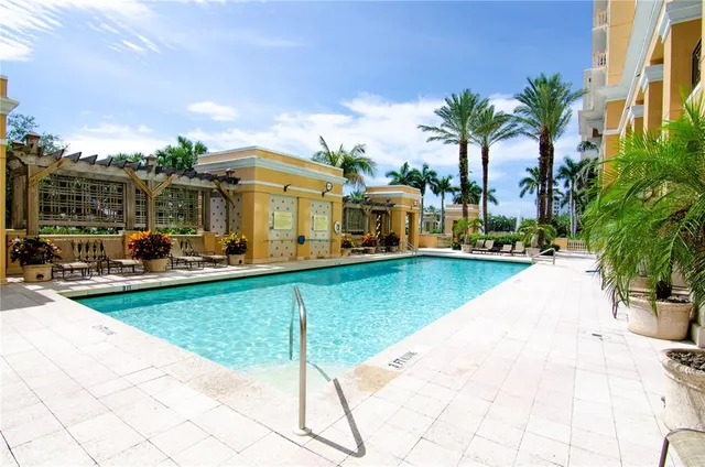 a view of a patio with table and chairs potted plants and palm trees