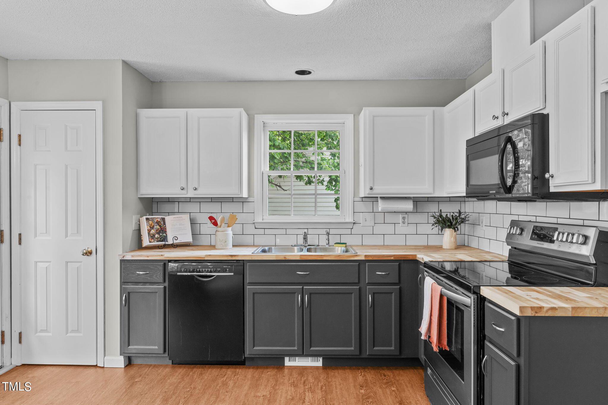 Undisclosed Address Garner, NC 27529 - Photo 13 of 31 a kitchen with stainless steel appliances granite countertop a stove a sink dishwasher and a microwave oven with wooden cabinets