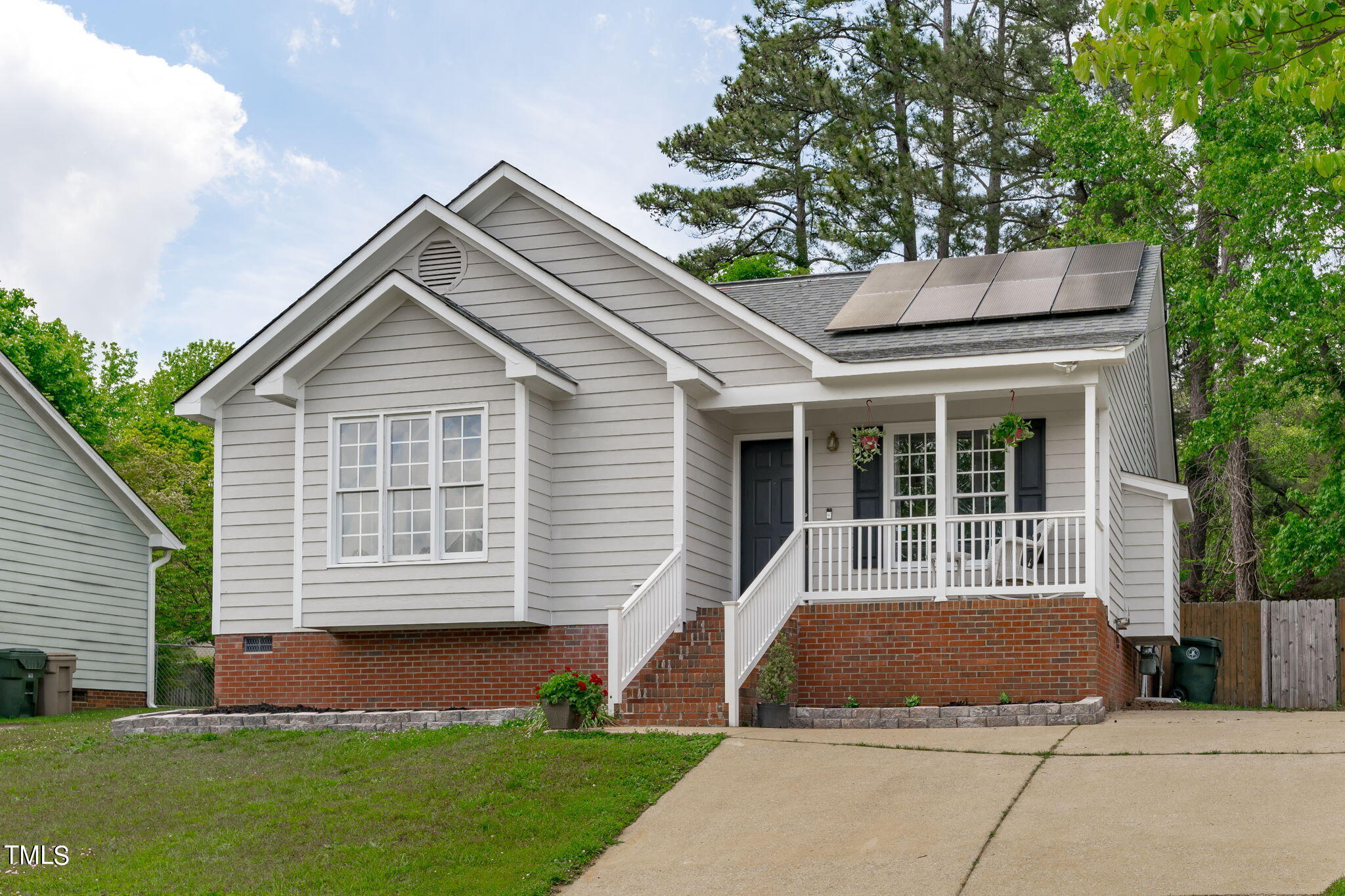 Undisclosed Address Garner, NC 27529 - Photo 2 of 31 a front view of a house with a yard and garage