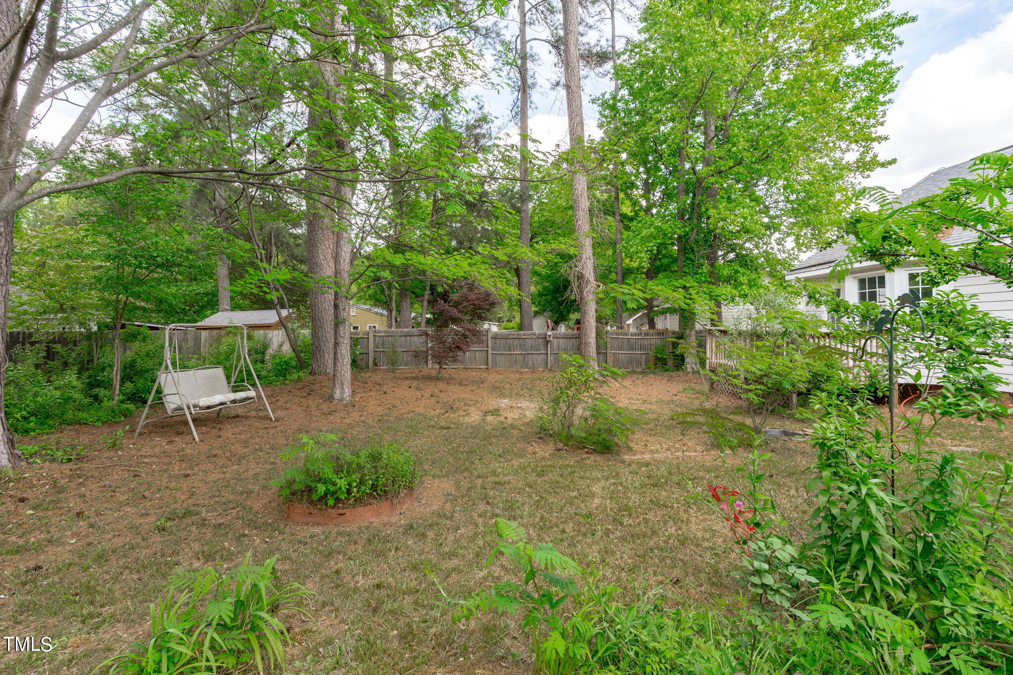 Undisclosed Address Garner, NC 27529 - Photo 31 of 31 a view of backyard with table and chairs plants and trees