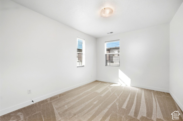 153 East Rochefort Court Sandy, UT 84070 - Photo 26 of 43 3rd bedroom. Two windows with blinds, neutral carpet, and a flush mount ceiling light
