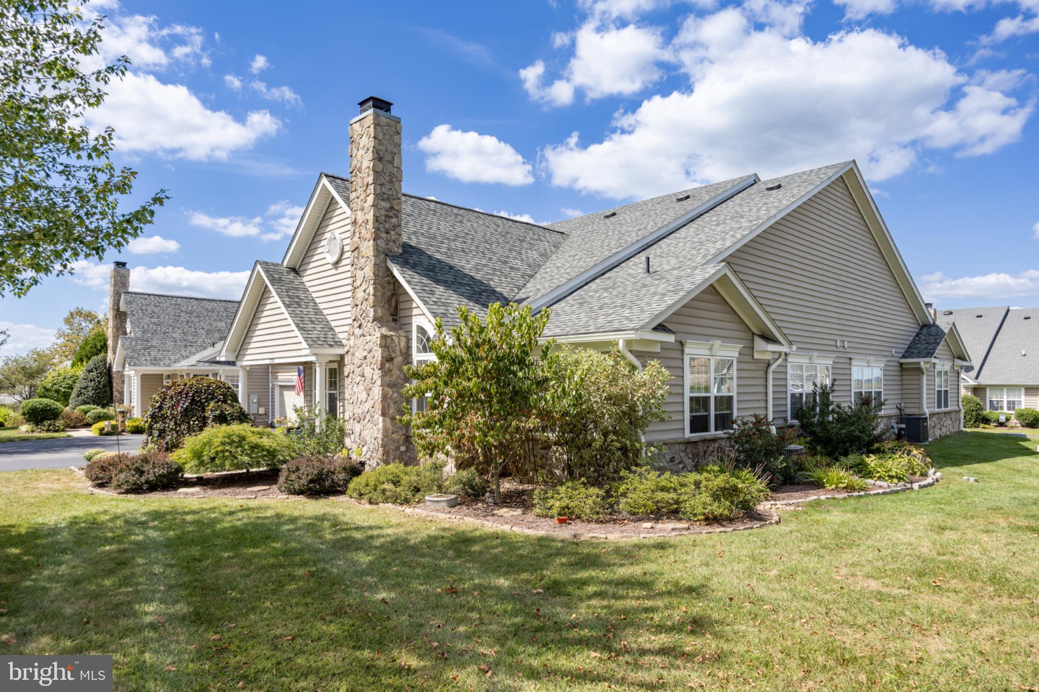 1701 Dawman Road Coatesville, PA 19320 - Photo 26 of 29 Charming home with lush landscaping and sky.