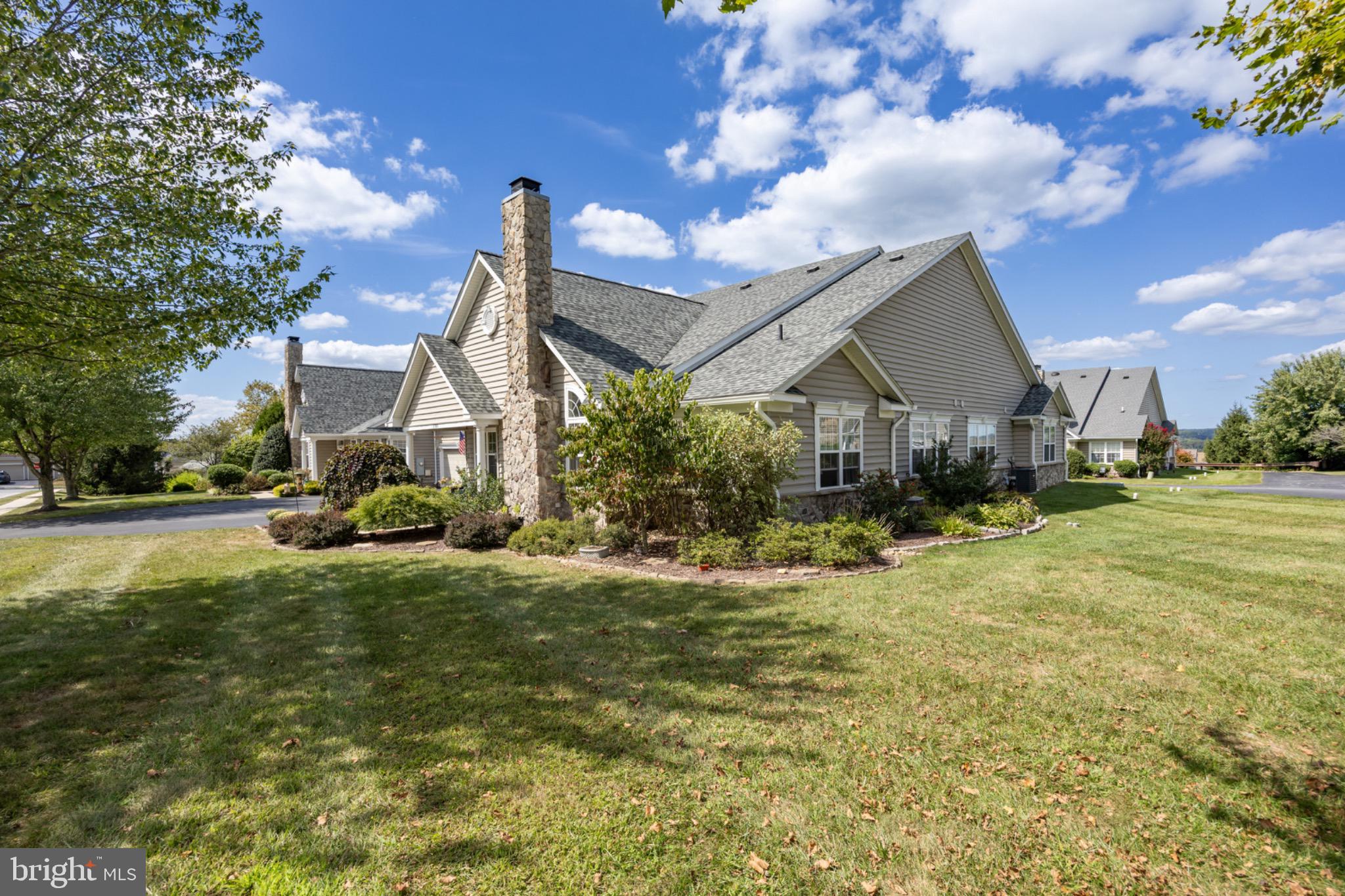 1701 Dawman Road Coatesville, PA 19320 - Photo 4 of 29 Charming home with lush greenery and blue skies.