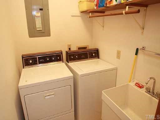 1432 Kildaire Farm Road Cary, NC 27511 - Photo 12 of 17 The laundry room with utility sink is conveniently located near the 1st. floor bedrooms.