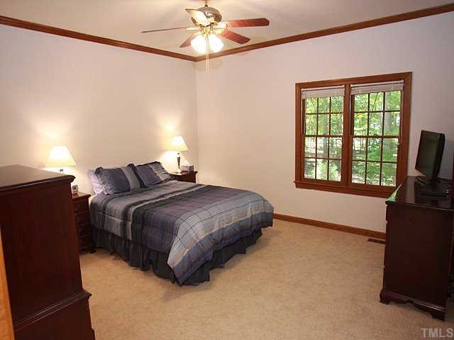 1432 Kildaire Farm Road Cary, NC 27511 - Photo 7 of 17 This large master bedroom on the first floor is so very comfortable with views of the woods outside, Note the new neutral carpet.
