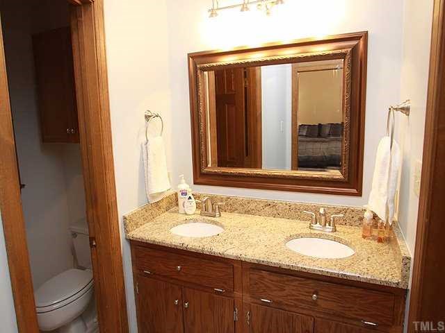 1432 Kildaire Farm Road Cary, NC 27511 - Photo 8 of 17 The master bath has a lovely framed mirrow over dual sinks with granite countertops.
