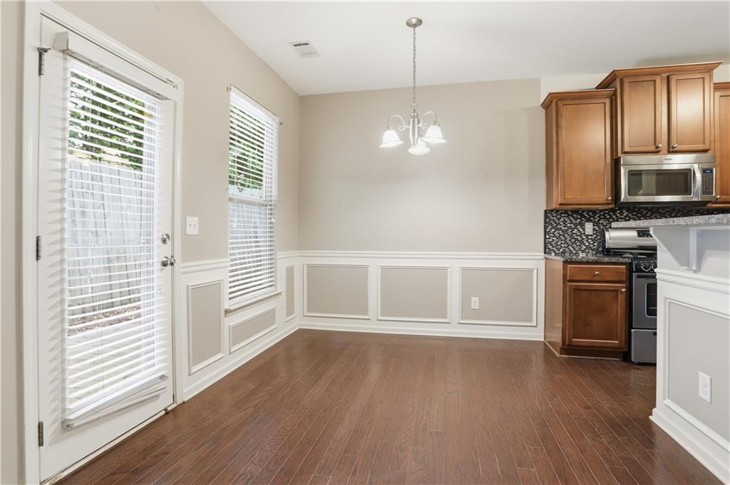 236 Manous Way Canton, GA 30115 - Photo 7 of 25 a view of a kitchen with a sink wooden cabinet and a refrigerator