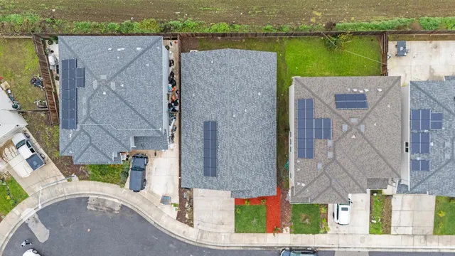 an aerial view of a house with a yard and lake view