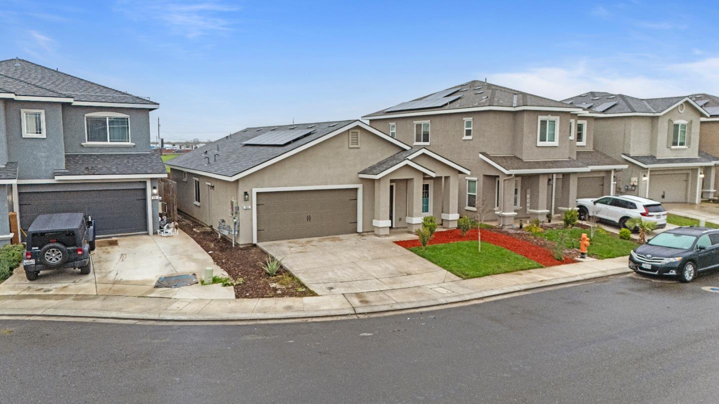 683 Granada Court Merced, CA 95341 - Photo 2 of 14 a front view of a house with garden