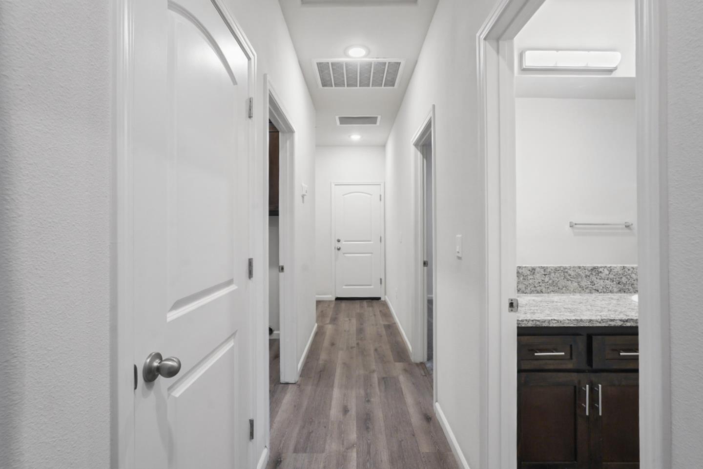 683 Granada Court Merced, CA 95341 - Photo 7 of 14 a view of a hallway with wooden floor and staircase