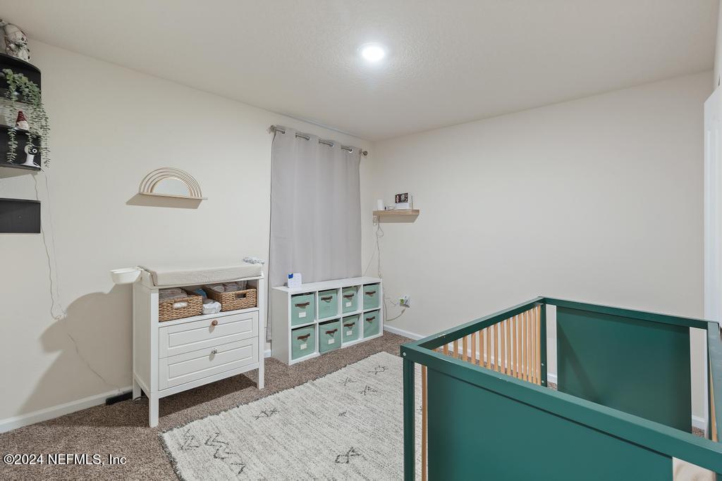 11291 Sheepshead Lane Jacksonville, FL 32226 - Photo 12 of 54 a view of a bedroom with furniture and window