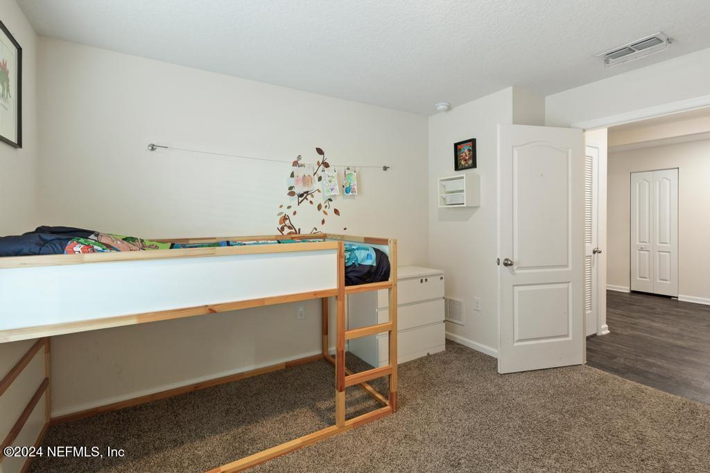 11291 Sheepshead Lane Jacksonville, FL 32226 - Photo 17 of 54 a room with chair and white cabinets
