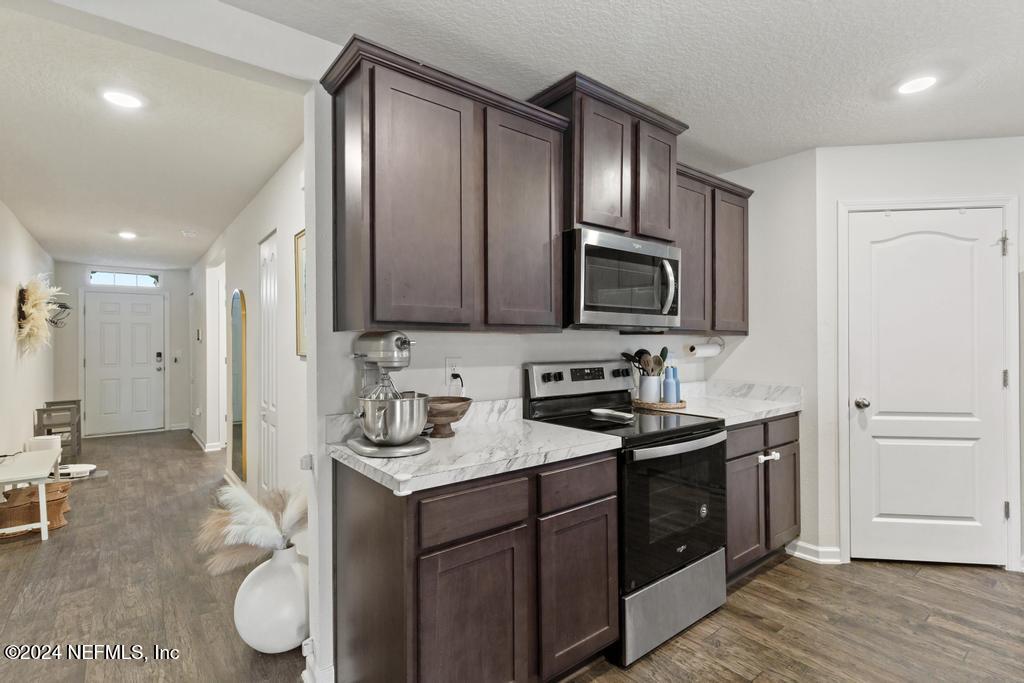 11291 Sheepshead Lane Jacksonville, FL 32226 - Photo 18 of 54 a kitchen with stainless steel appliances granite countertop a sink stove and refrigerator