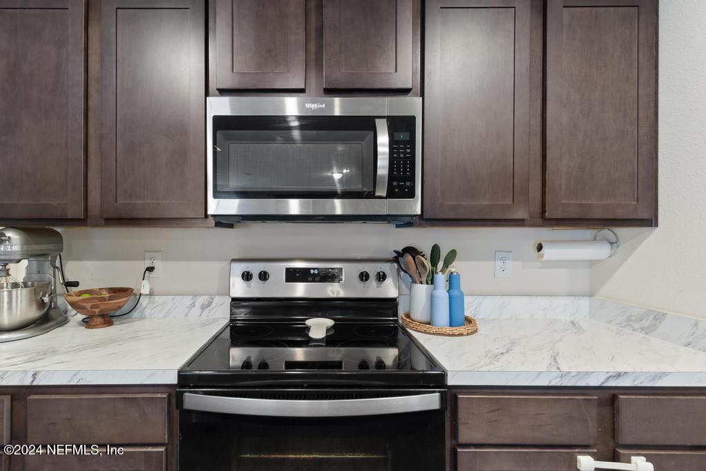 11291 Sheepshead Lane Jacksonville, FL 32226 - Photo 19 of 54 a kitchen with a stove and a microwave