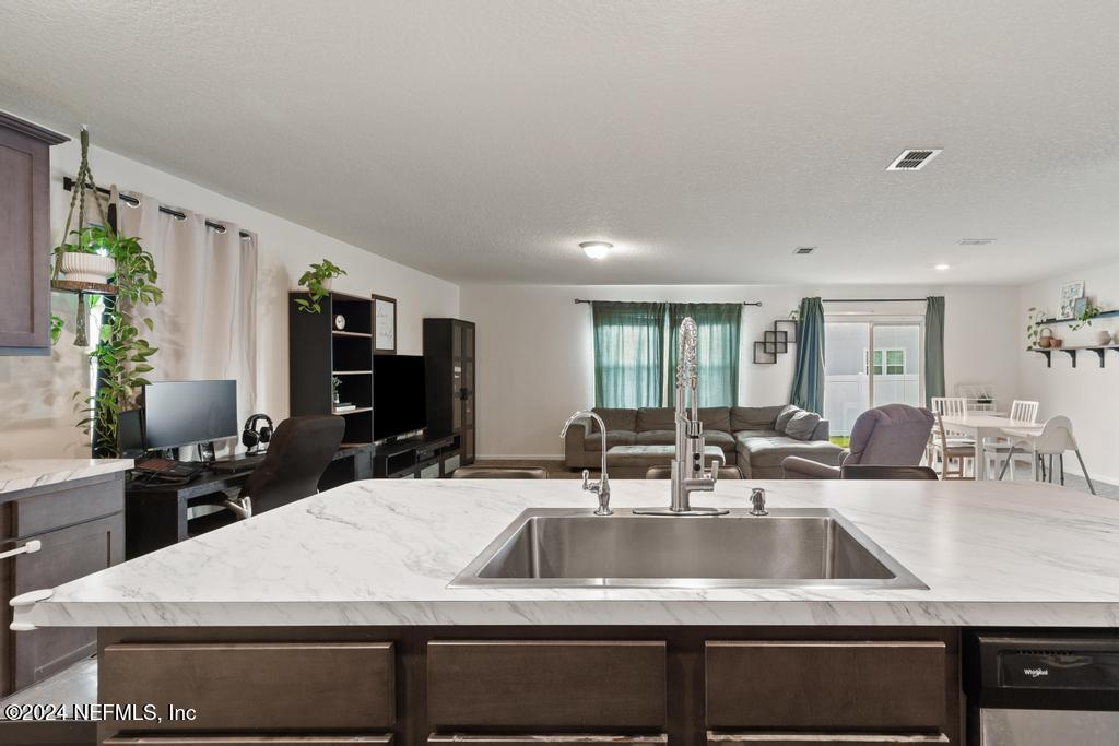11291 Sheepshead Lane Jacksonville, FL 32226 - Photo 24 of 54 a view of kitchen island a sink and living room