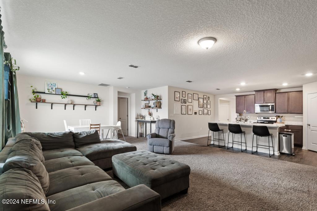 11291 Sheepshead Lane Jacksonville, FL 32226 - Photo 26 of 54 a living room with furniture and kitchen view