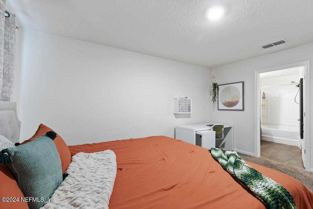 11291 Sheepshead Lane Jacksonville, FL 32226 - Photo 31 of 54 a bedroom with a bed and wooden floor