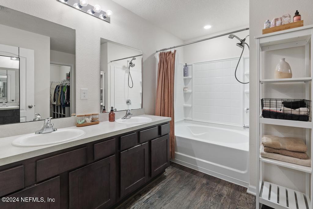 11291 Sheepshead Lane Jacksonville, FL 32226 - Photo 33 of 54 a bathroom with a double vanity sink mirror and shower