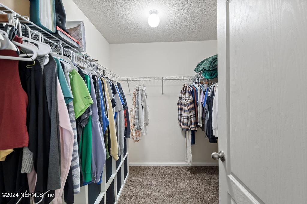 11291 Sheepshead Lane Jacksonville, FL 32226 - Photo 36 of 54 a view of walk in closet with clothes